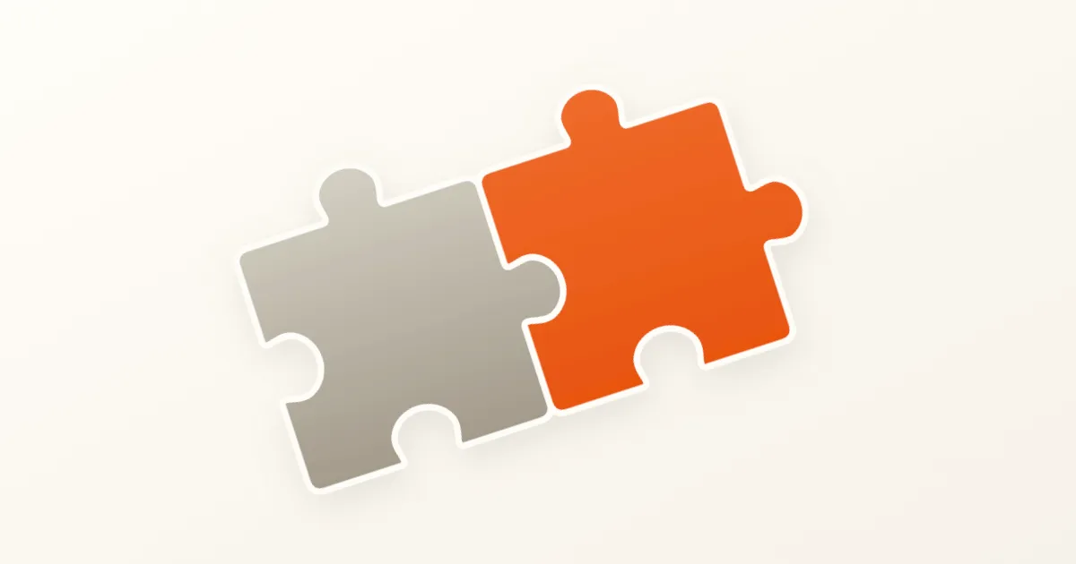 Two equally sized interlocking jigsaw puzzle pieces, one warm taupe and one orange, tilted diagonally on a cream background