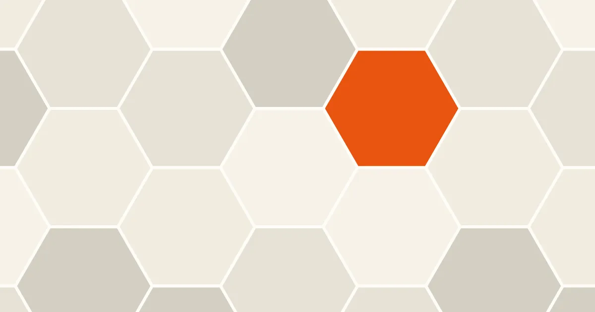 An edge-to-edge pattern of cream and warm beige hexagons with one orange hexagon near the upper right