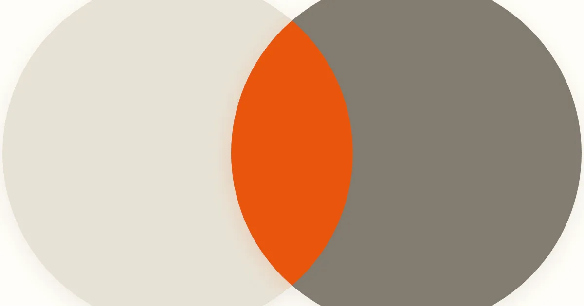 Two oversized circles, one pale beige and one dark taupe, overlap in a bright orange lens on a warm cream background